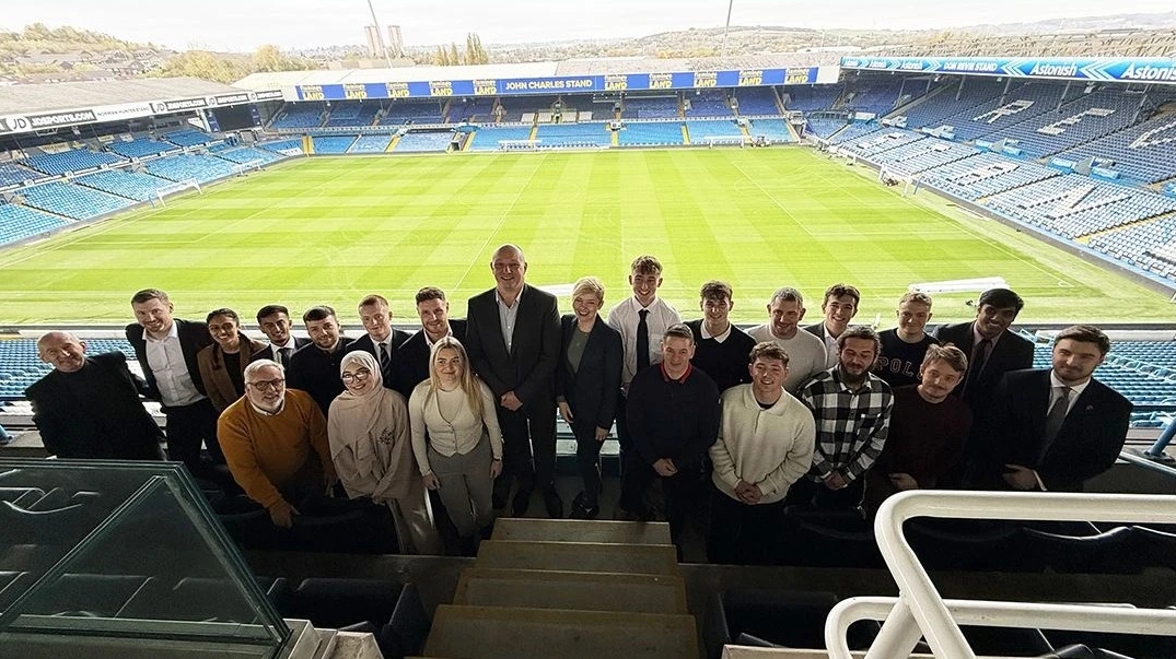 William Hare Group award winners pictured in the stand with the Elland Road pitch behind them.